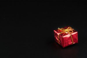 Christmass,Tmass,Gift,In,Red,Paper,Isolated,At,Black,Background
